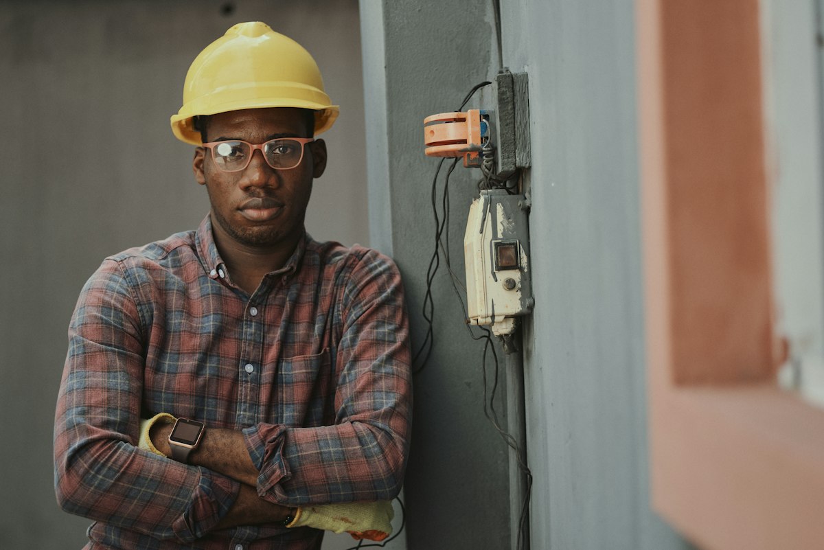 African construction worker in work helmet